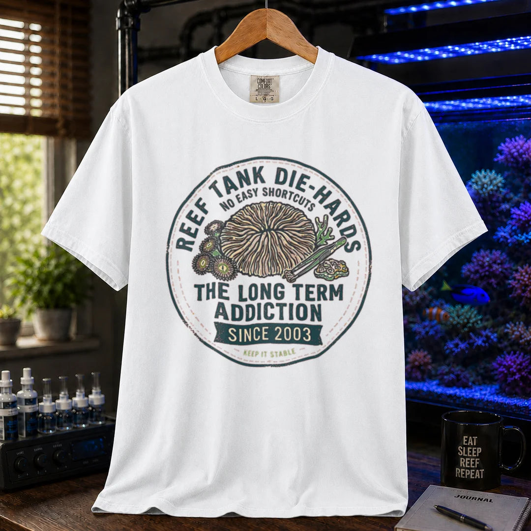 Saltwater aquarium graphic t-shirt featuring a circular vintage emblem illustration and text: REEF TANK DIE-HARDS THE LONG TERM ADDICTION SINCE 2003, white crew neck tee
