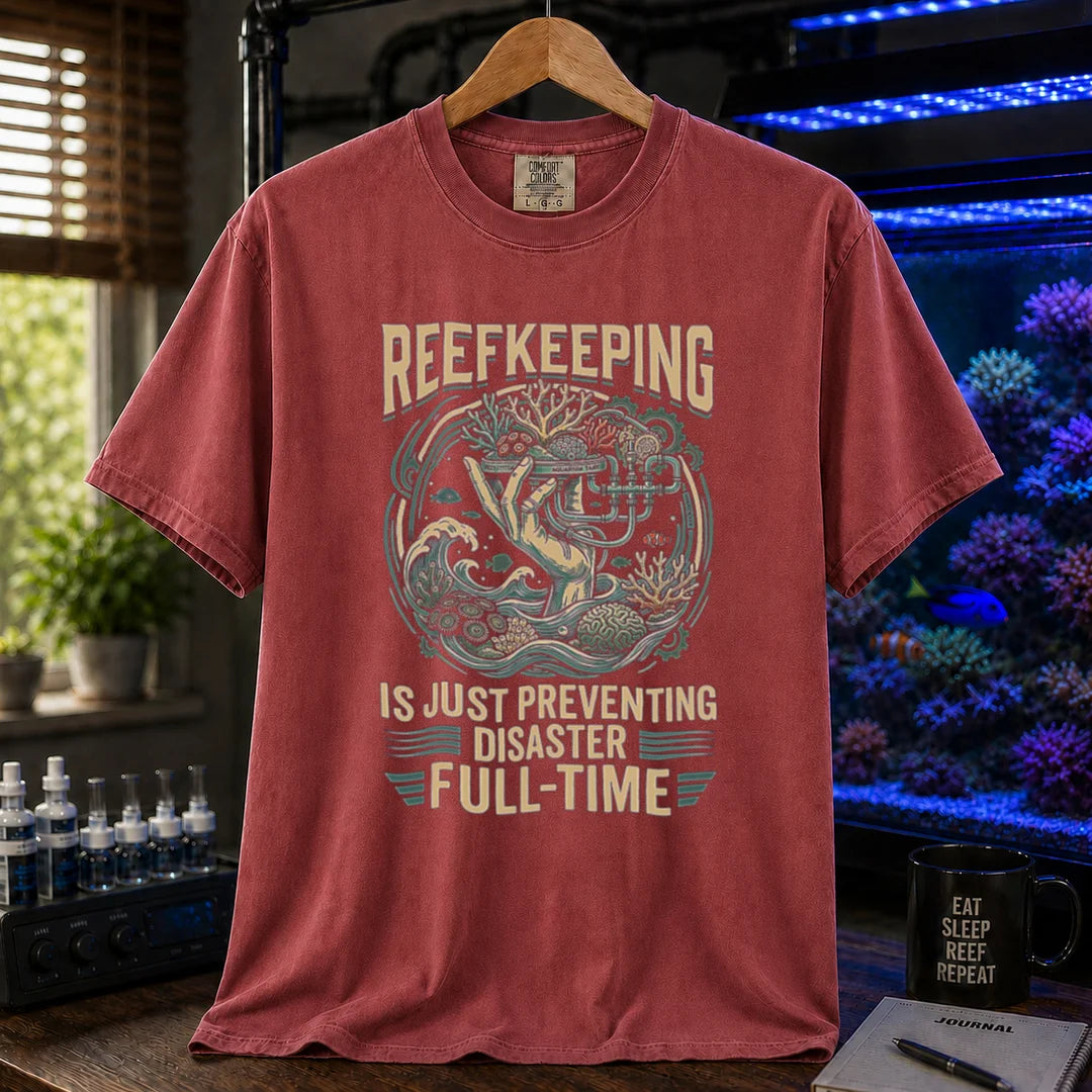 Saltwater aquarium graphic t-shirt featuring an intricate illustration and text: REEFKEEPING IS JUST PREVENTING DISASTER FULL-TIME, maroon crew neck tee