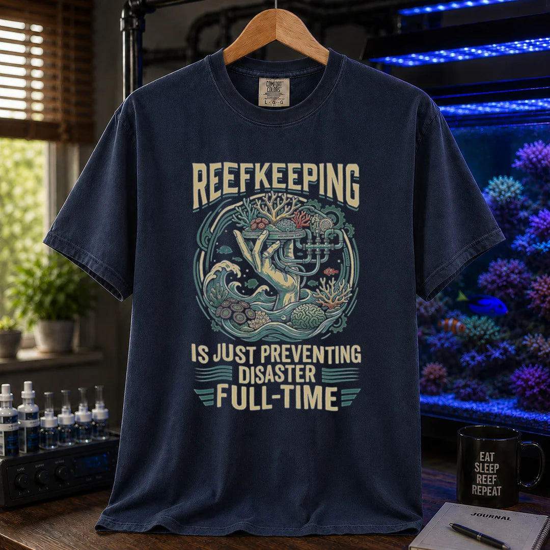 Saltwater aquarium graphic t-shirt featuring an intricate illustration and text: REEFKEEPING IS JUST PREVENTING DISASTER FULL-TIME, navy crew neck tee