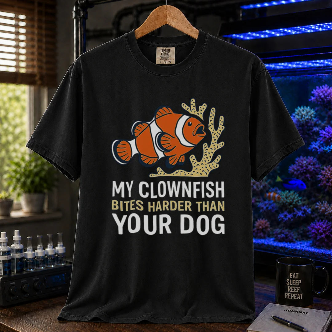 Saltwater aquarium graphic t-shirt featuring a clownfish and coral illustration with text: MY CLOWNFISH BITES HARDER THAN YOUR DOG, black crew neck tee