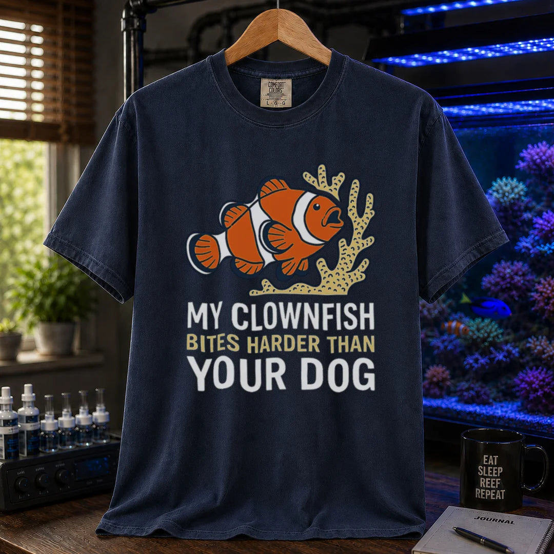 Saltwater aquarium graphic t-shirt featuring a clownfish and coral illustration with text: MY CLOWNFISH BITES HARDER THAN YOUR DOG, navy crew neck tee