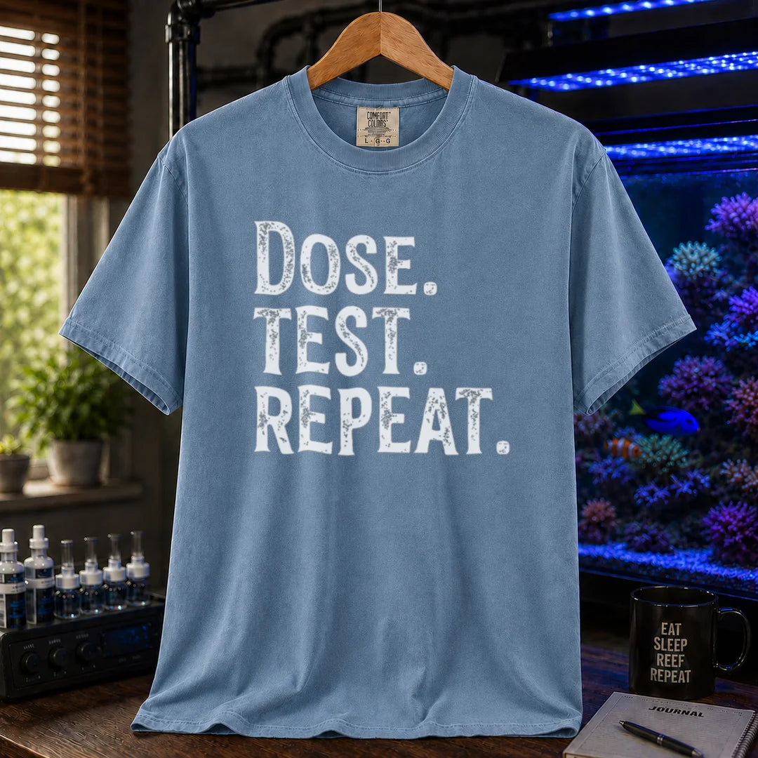 Saltwater aquarium graphic t-shirt featuring bold distressed text: DOSE. TEST. REPEAT., blue crew neck tee