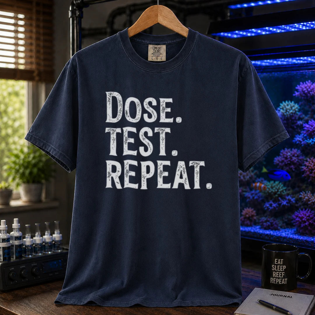 Saltwater aquarium graphic t-shirt featuring bold distressed text: DOSE. TEST. REPEAT., navy crew neck tee