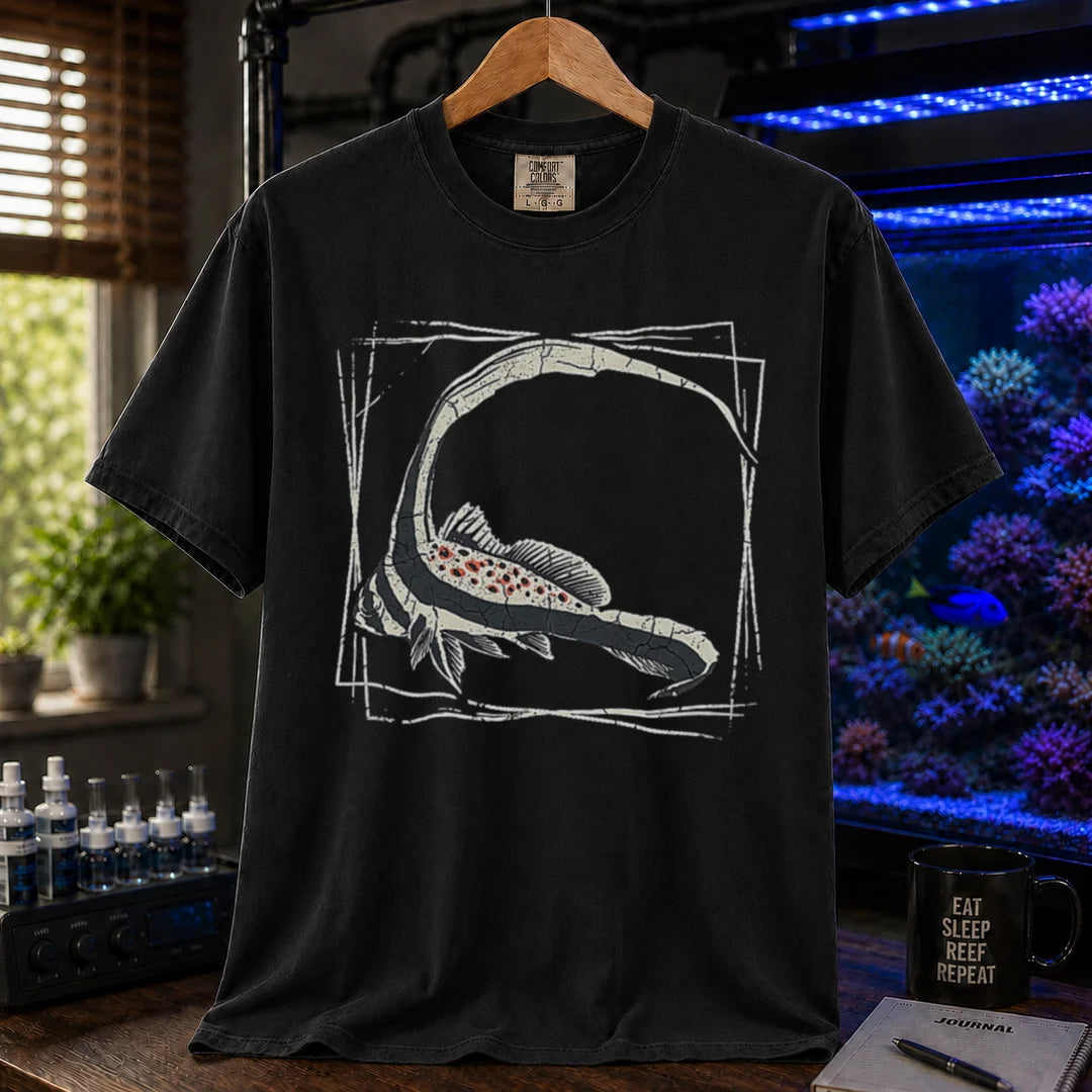 Saltwater aquarium graphic t-shirt featuring a detailed illustration of a spotted drum fish inside a geometric frame, black crew neck tee