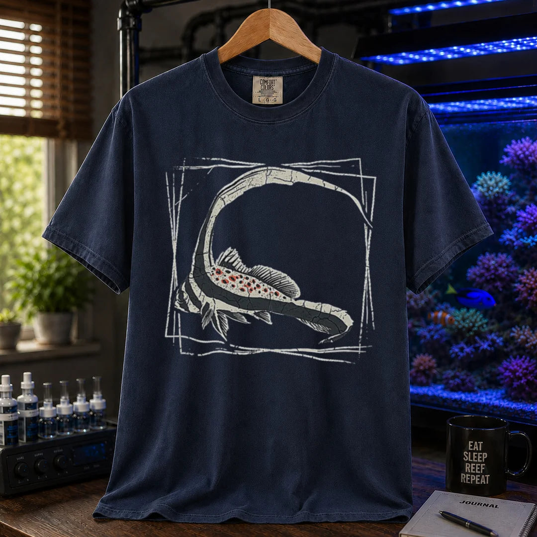Saltwater aquarium graphic t-shirt featuring a detailed illustration of a spotted drum fish inside a geometric frame, navy crew neck tee