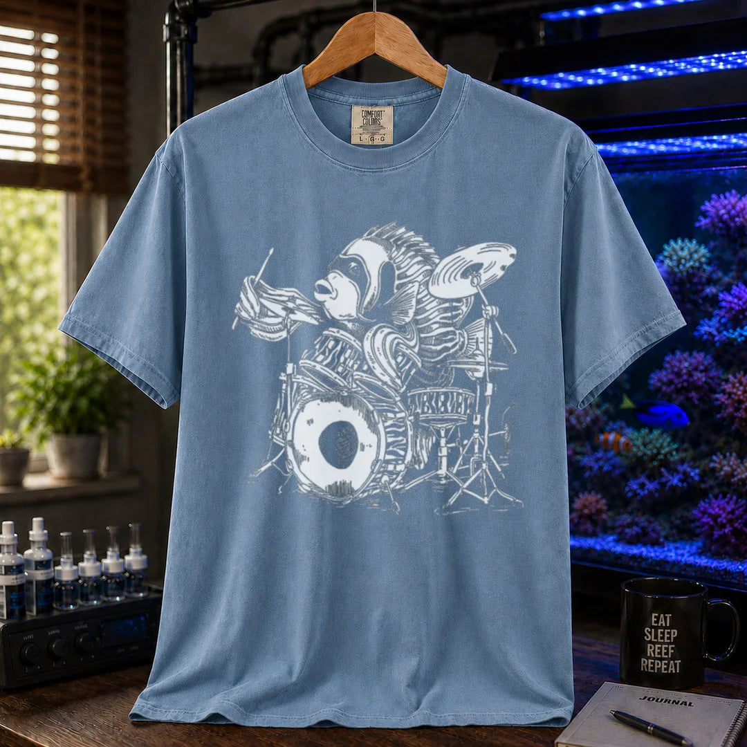 Saltwater aquarium graphic t-shirt featuring a detailed illustration of a spotted drum fish playing a drum kit, blue crew neck tee