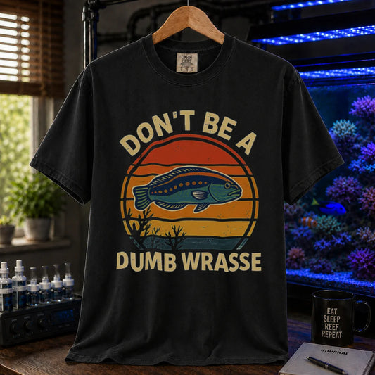 Saltwater aquarium graphic t-shirt featuring a retro sunset and wrasse illustration with text: DON'T BE A DUMB WRASSE, black crew neck tee