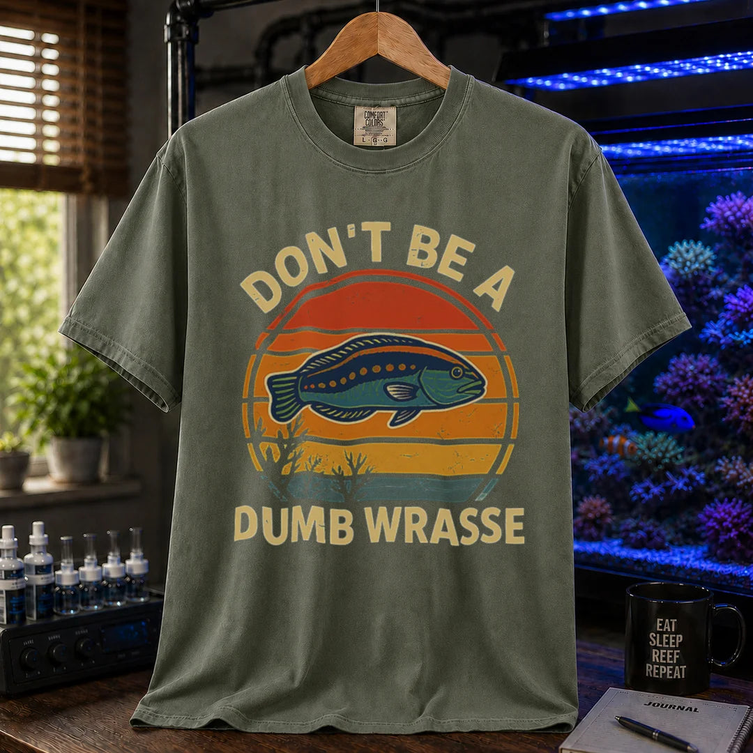 Saltwater aquarium graphic t-shirt featuring a retro sunset and wrasse illustration with text: DON'T BE A DUMB WRASSE, military green crew neck tee