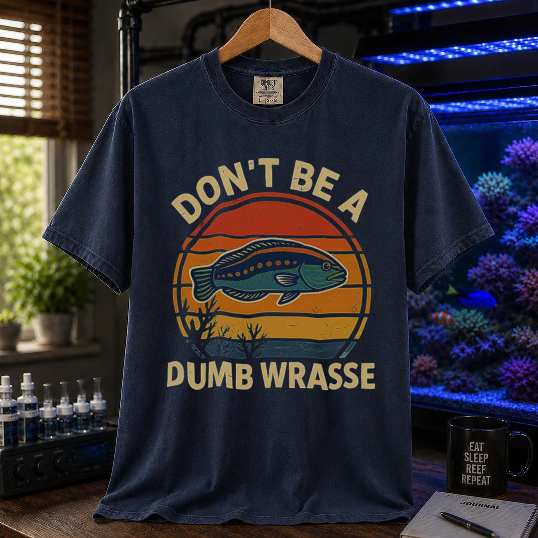 Saltwater aquarium graphic t-shirt featuring a retro sunset and wrasse illustration with text: DON'T BE A DUMB WRASSE, navy crew neck tee