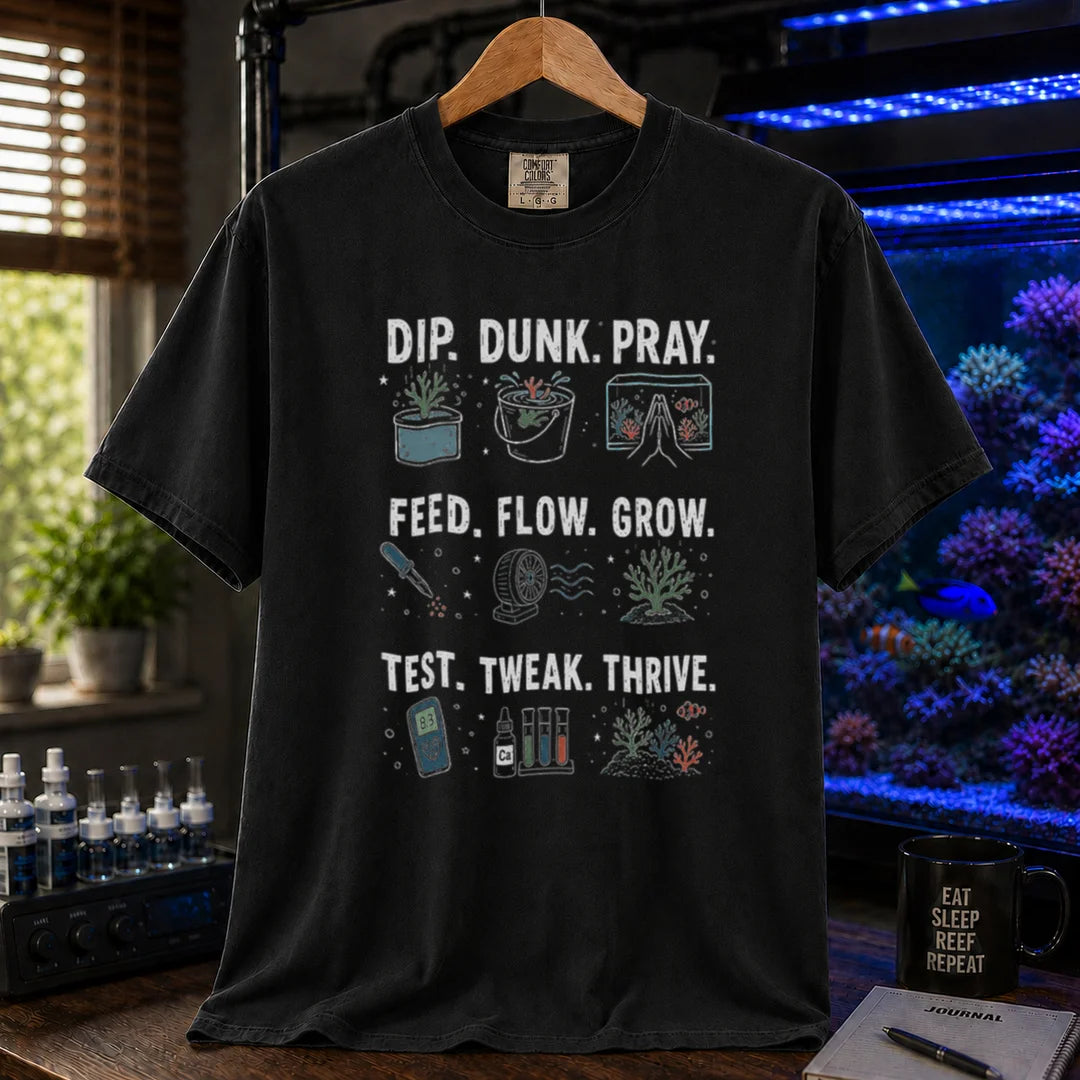 Saltwater aquarium graphic t-shirt featuring multi-step routine icons and text: DIP. DUNK. PRAY. FEED. FLOW. GROW. TEST. TWEAK. THRIVE., black crew neck tee