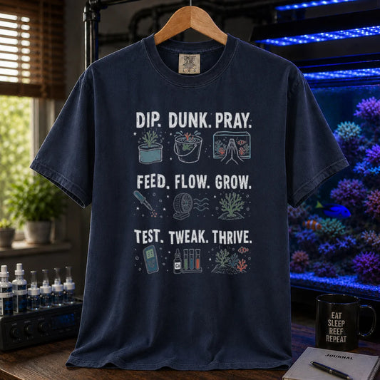 Saltwater aquarium graphic t-shirt featuring multi-step routine icons and text: DIP. DUNK. PRAY. FEED. FLOW. GROW. TEST. TWEAK. THRIVE., navy crew neck tee