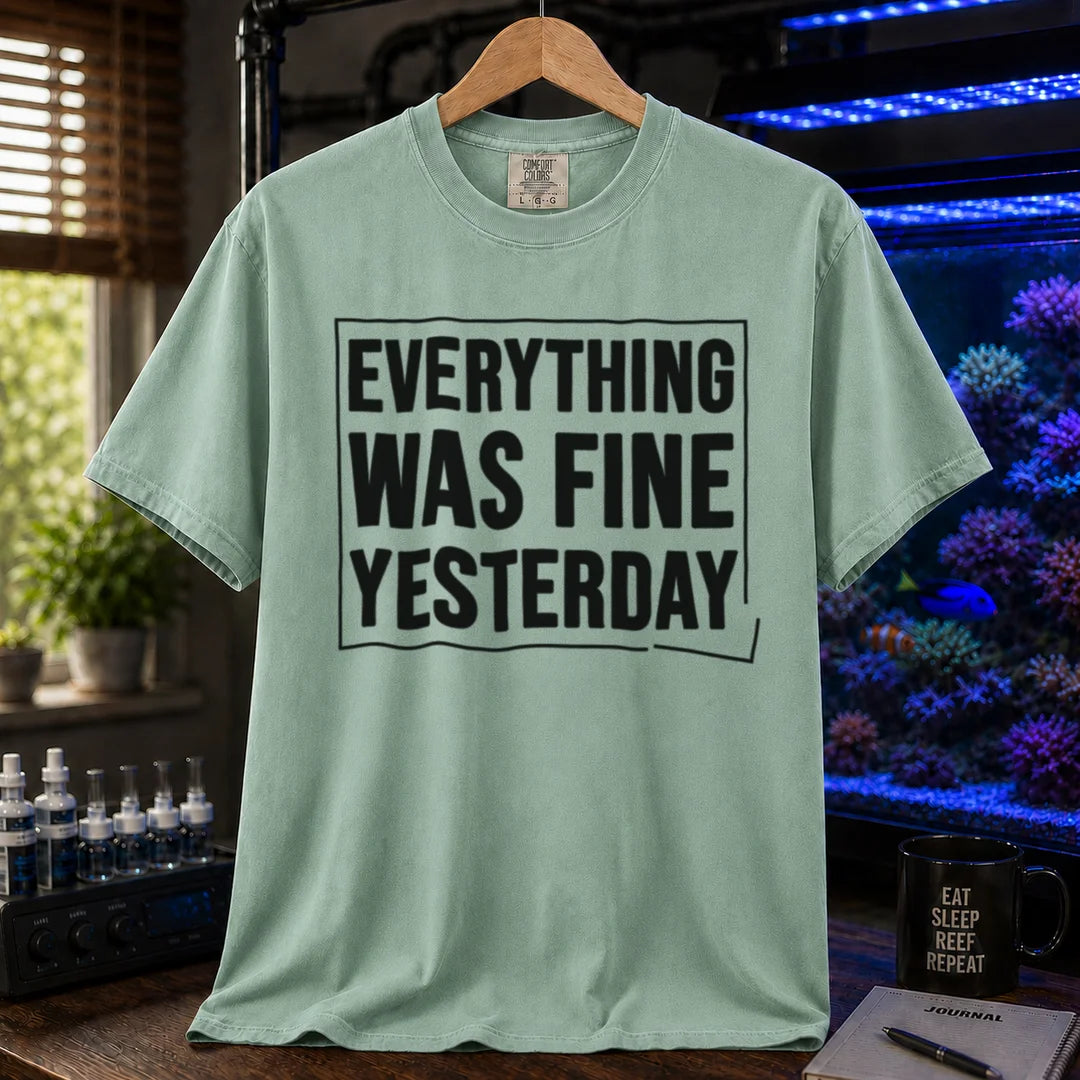 Saltwater aquarium graphic t-shirt featuring framed bold text: EVERYTHING WAS FINE YESTERDAY, green crew neck tee
