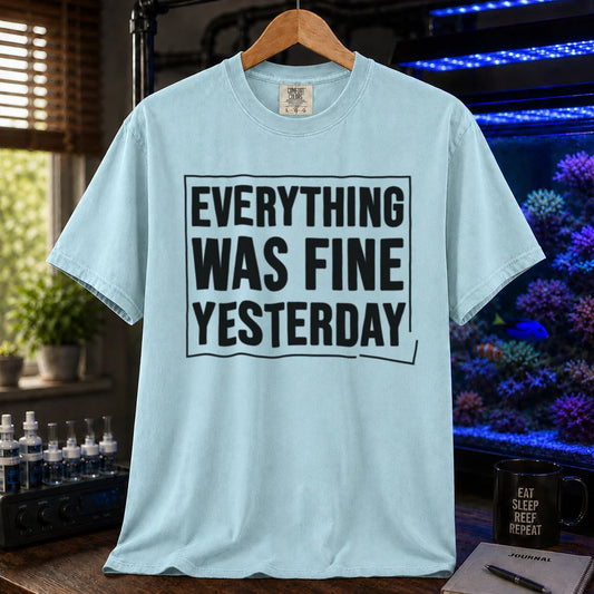 Saltwater aquarium graphic t-shirt featuring framed bold text: EVERYTHING WAS FINE YESTERDAY, light blue crew neck tee