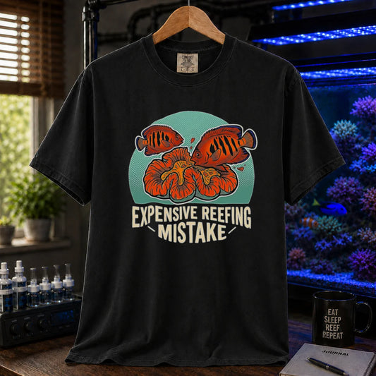 Saltwater aquarium graphic t-shirt featuring vibrant fish and coral illustrations and text: EXPENSIVE REEFING MISTAKE, black crew neck tee