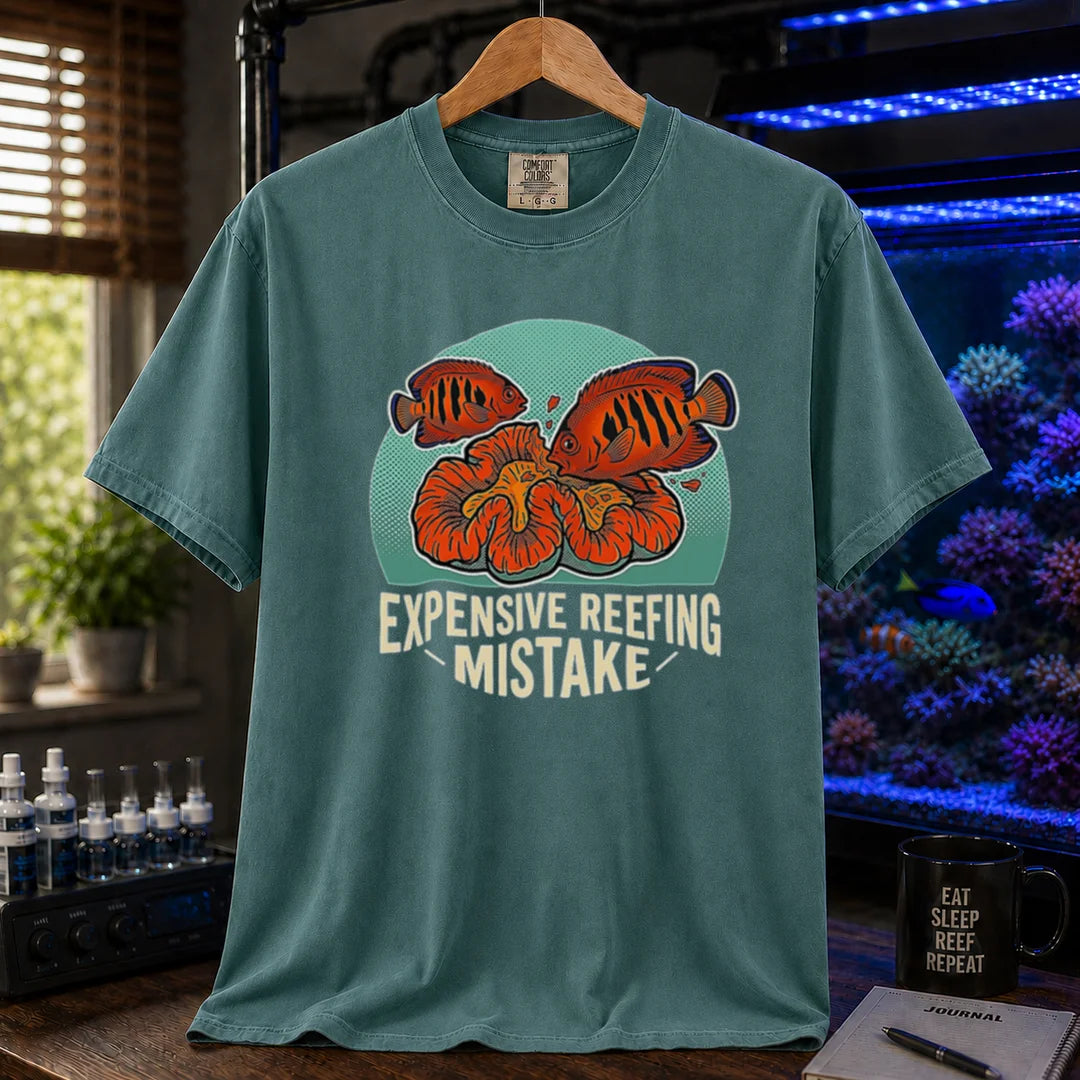 Saltwater aquarium graphic t-shirt featuring vibrant fish and coral illustrations and text: EXPENSIVE REEFING MISTAKE, green crew neck tee
