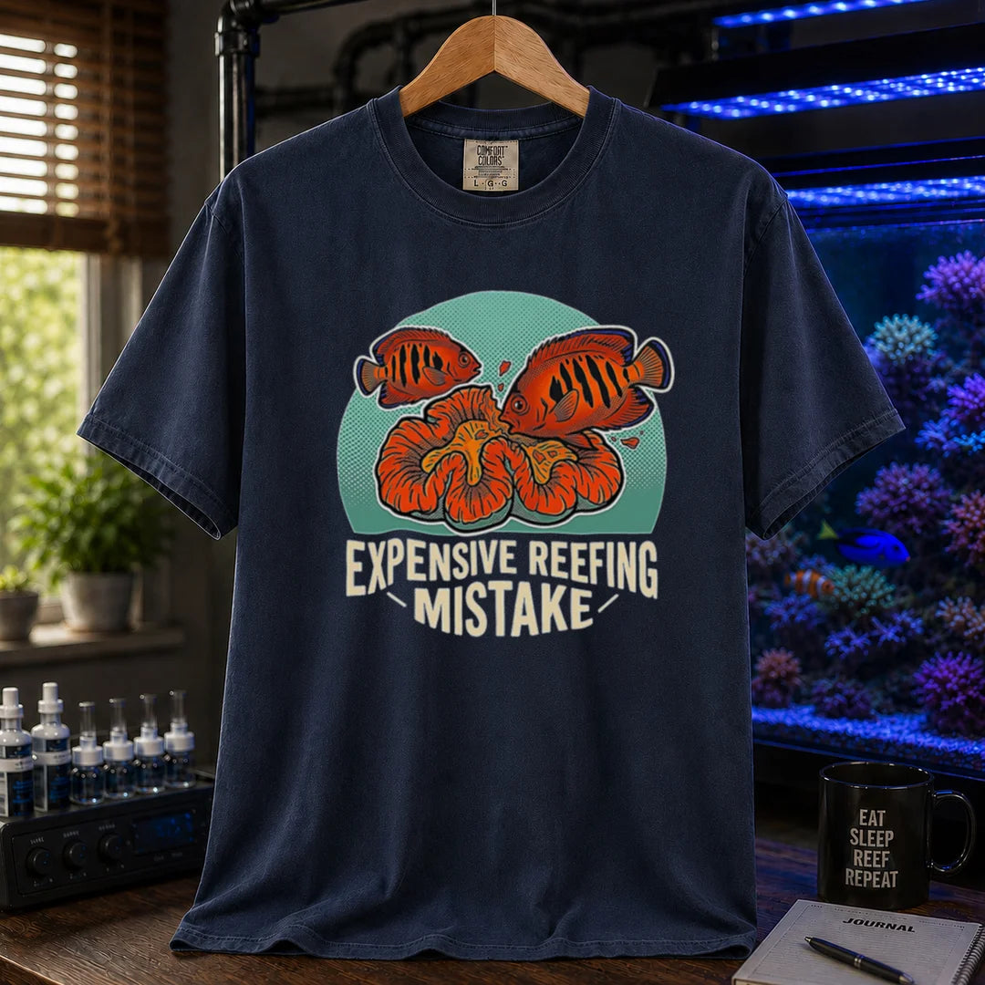 Saltwater aquarium graphic t-shirt featuring vibrant fish and coral illustrations and text: EXPENSIVE REEFING MISTAKE, navy crew neck tee