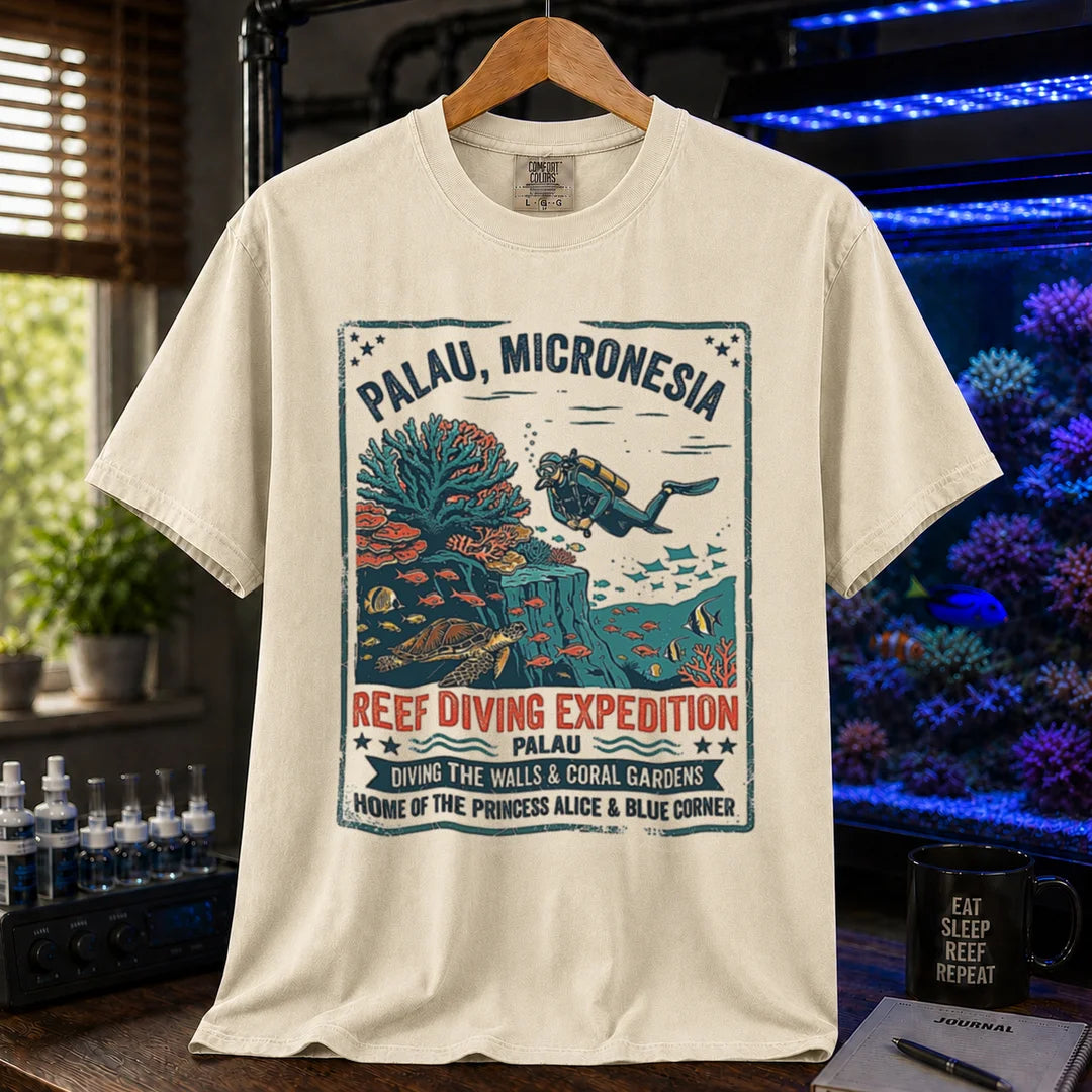 Saltwater aquarium graphic t-shirt featuring a vintage Palau diving expedition badge and text: PALAU, MICRONESIA REEF DIVING EXPEDITION, cream, beige, ivory crew neck tee