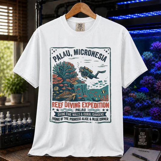 Saltwater aquarium graphic t-shirt featuring a vintage Palau diving expedition badge and text: PALAU, MICRONESIA REEF DIVING EXPEDITION, white crew neck tee