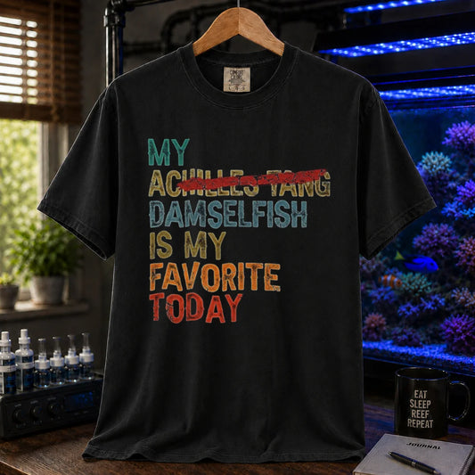 Saltwater aquarium graphic t-shirt featuring retro block text with a crossed-out fish reference: MY DAMSELFISH IS MY FAVORITE TODAY, black crew neck tee
