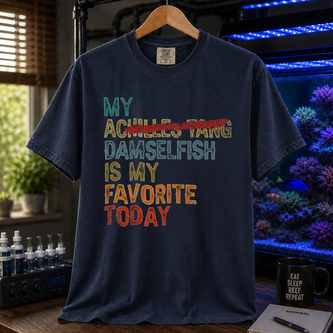 Saltwater aquarium graphic t-shirt featuring retro block text with a crossed-out fish reference: MY DAMSELFISH IS MY FAVORITE TODAY, navy crew neck tee