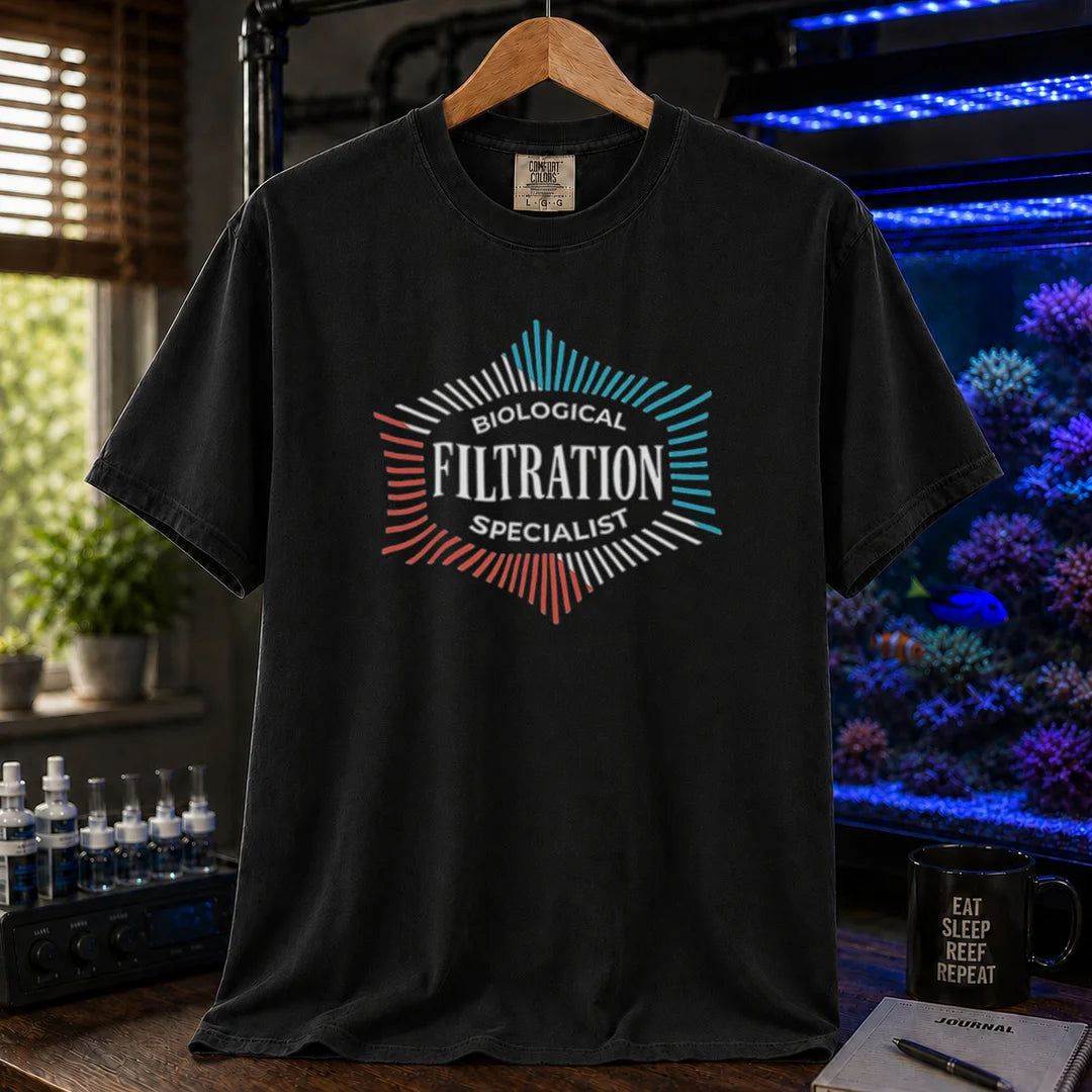 Saltwater aquarium graphic t-shirt featuring a geometric badge design and text: BIOLOGICAL FILTRATION SPECIALIST, black crew neck tee