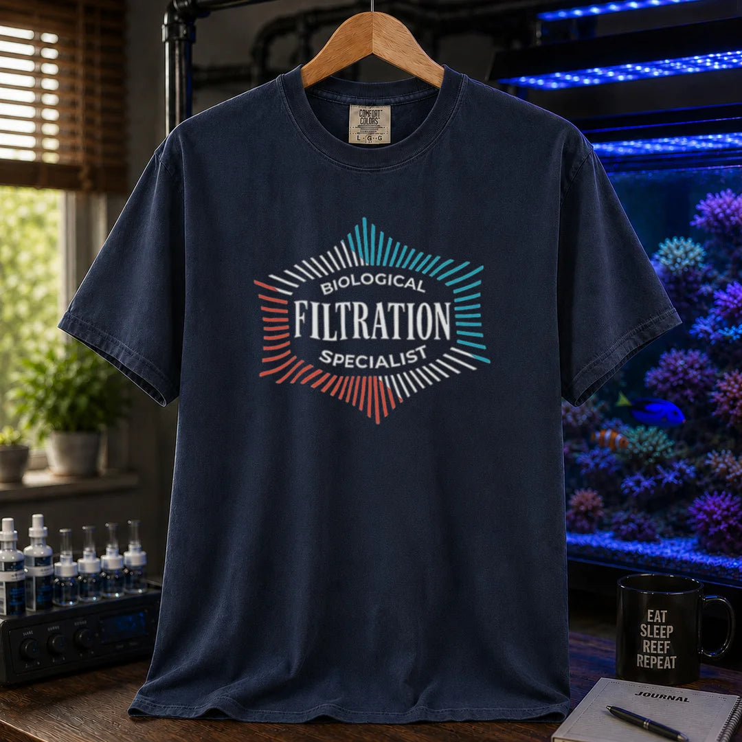 Saltwater aquarium graphic t-shirt featuring a geometric badge design and text: BIOLOGICAL FILTRATION SPECIALIST, navy crew neck tee