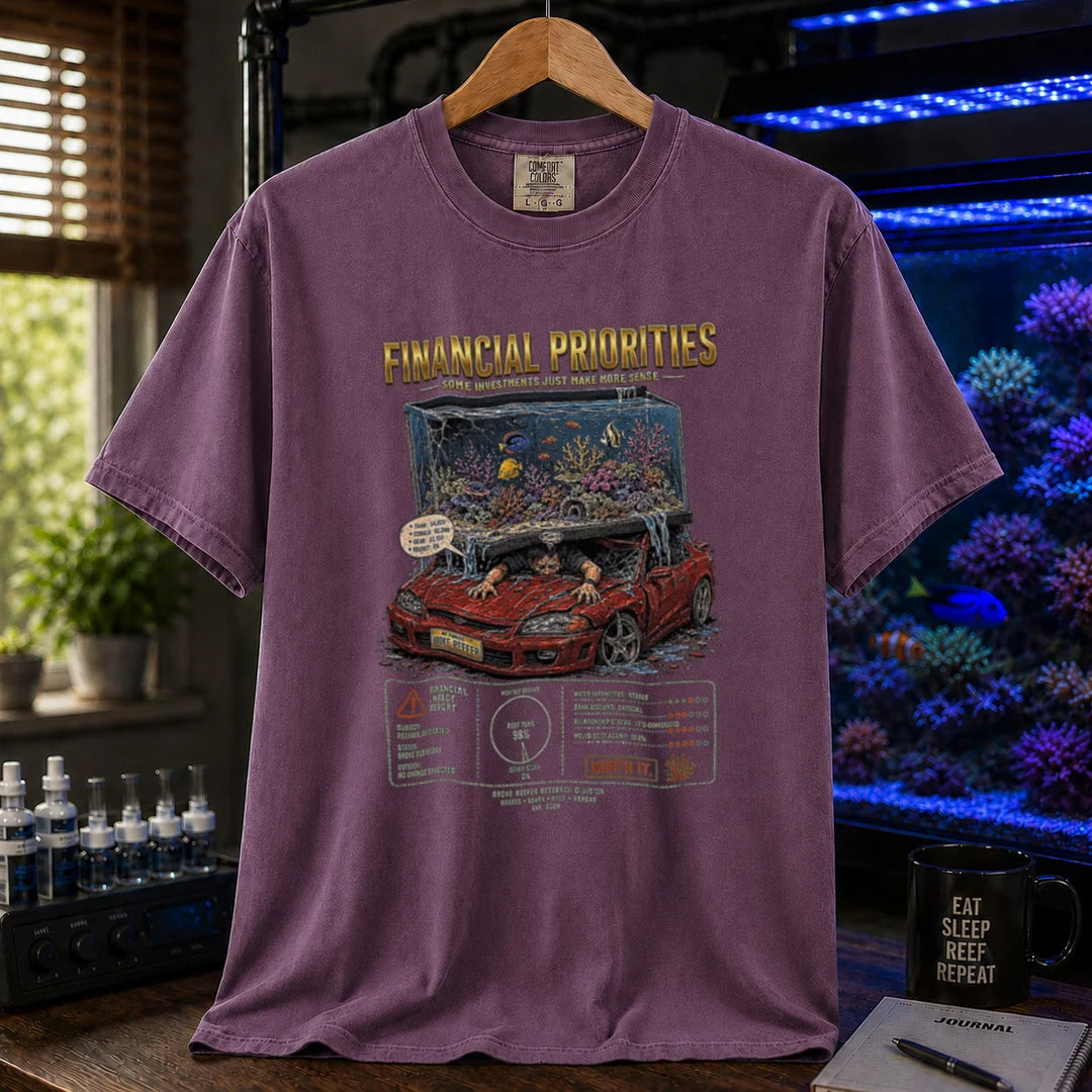Saltwater aquarium graphic t-shirt featuring a reef tank crushing a car illustration and text: FINANCIAL PRIORITIES, purple crew neck tee