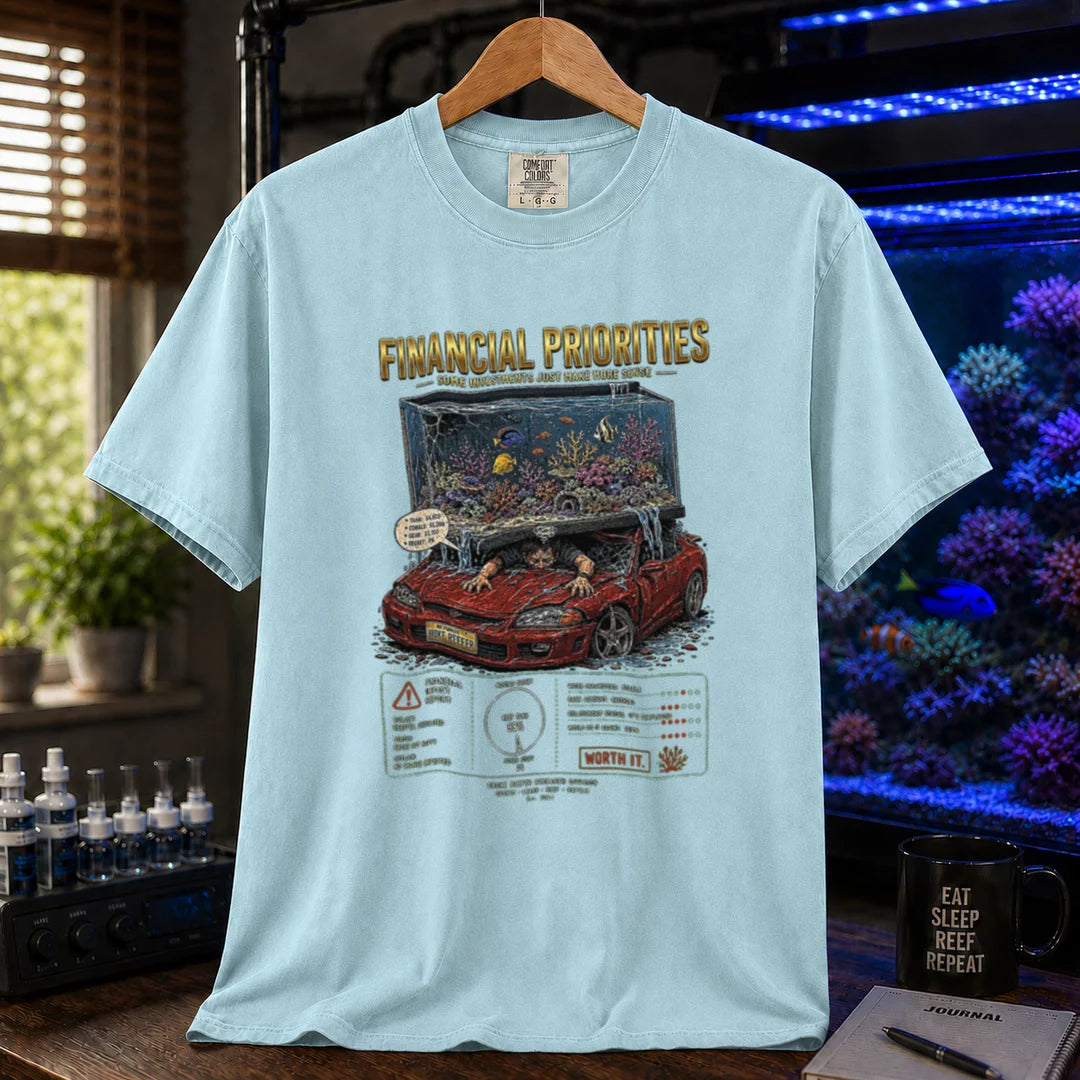 Saltwater aquarium graphic t-shirt featuring a reef tank crushing a car illustration and text: FINANCIAL PRIORITIES, light blue crew neck tee