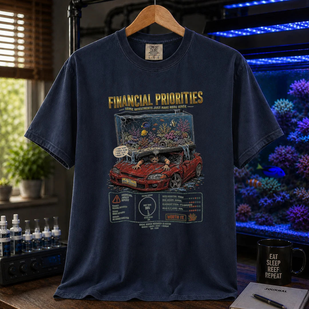 Saltwater aquarium graphic t-shirt featuring a reef tank crushing a car illustration and text: FINANCIAL PRIORITIES, navy crew neck tee