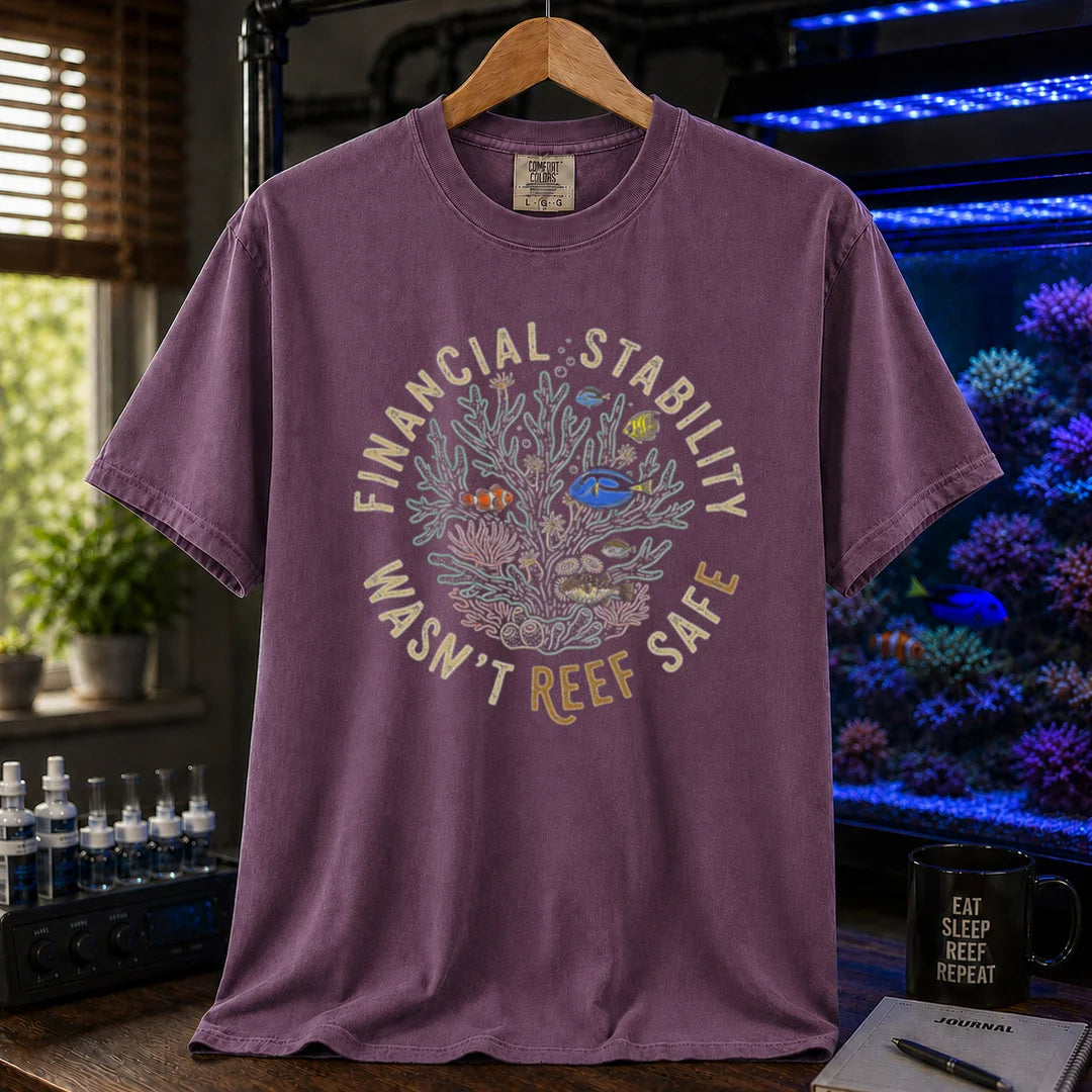 Saltwater aquarium graphic t-shirt featuring a circular coral reef illustration and text: FINANCIAL STABILITY WASN'T REEF SAFE, purple crew neck tee