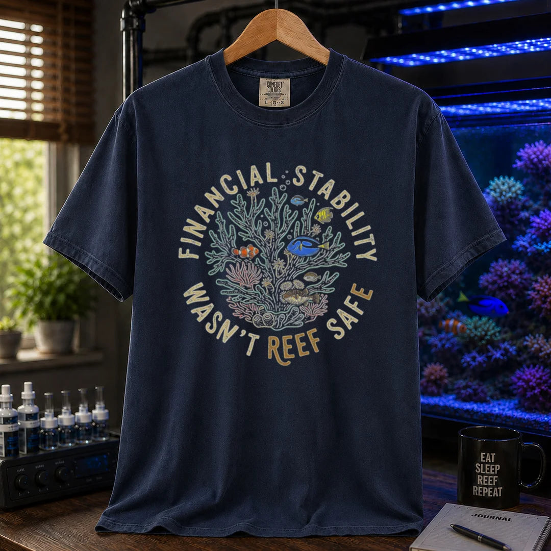 Saltwater aquarium graphic t-shirt featuring a circular coral reef illustration and text: FINANCIAL STABILITY WASN'T REEF SAFE, navy crew neck tee