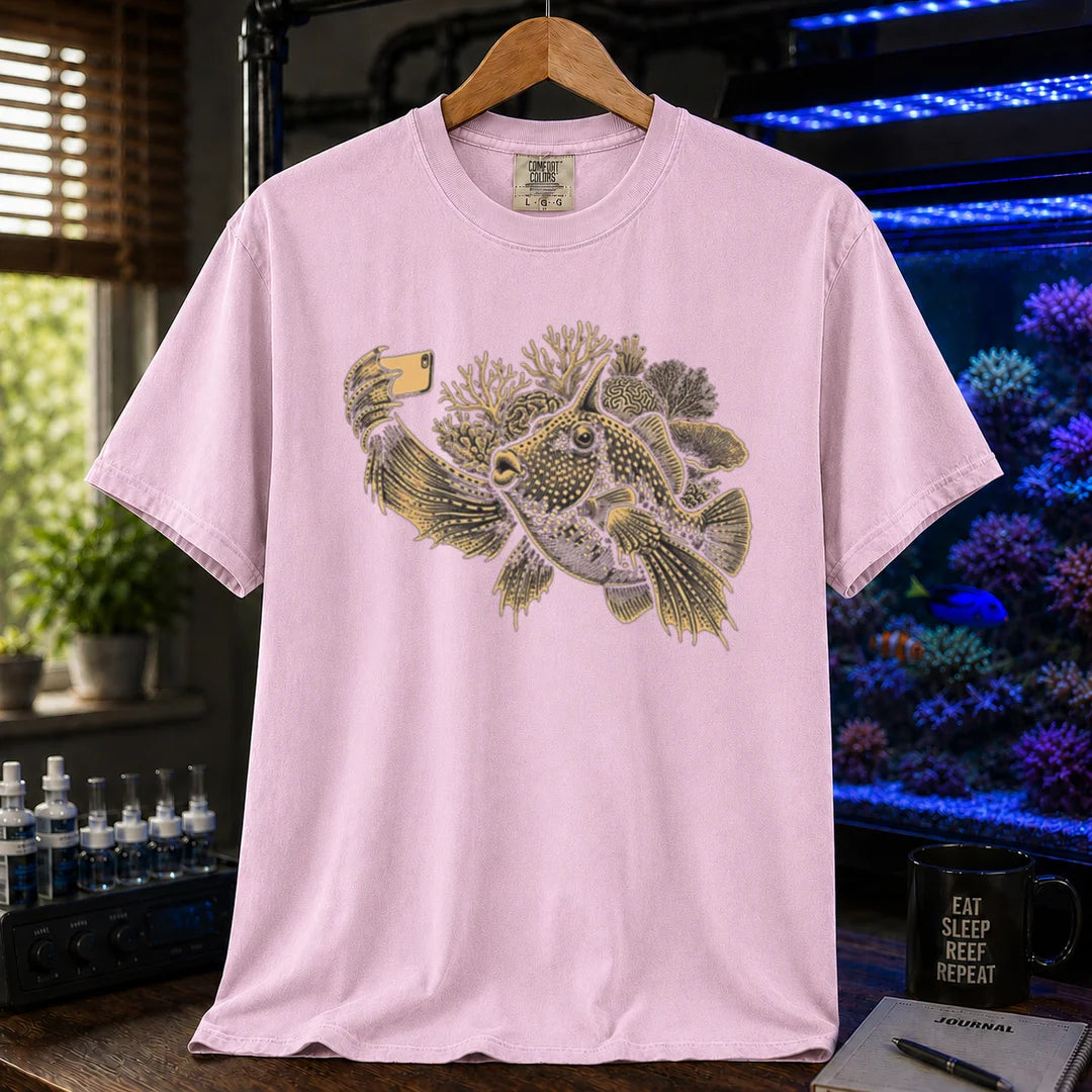 Saltwater aquarium graphic t-shirt featuring a fish taking a selfie illustration with corals, pink crew neck tee