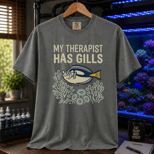 Saltwater aquarium graphic t-shirt featuring a tang and coral line art illustration with text: MY THERAPIST HAS GILLS, grey crew neck tee