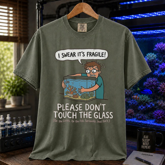 Saltwater aquarium graphic t-shirt featuring an anxious aquarist hugging a tank illustration and text: I SWEAR IT'S FRAGILE! PLEASE DON'T TOUCH THE GLASS, military green crew neck tee