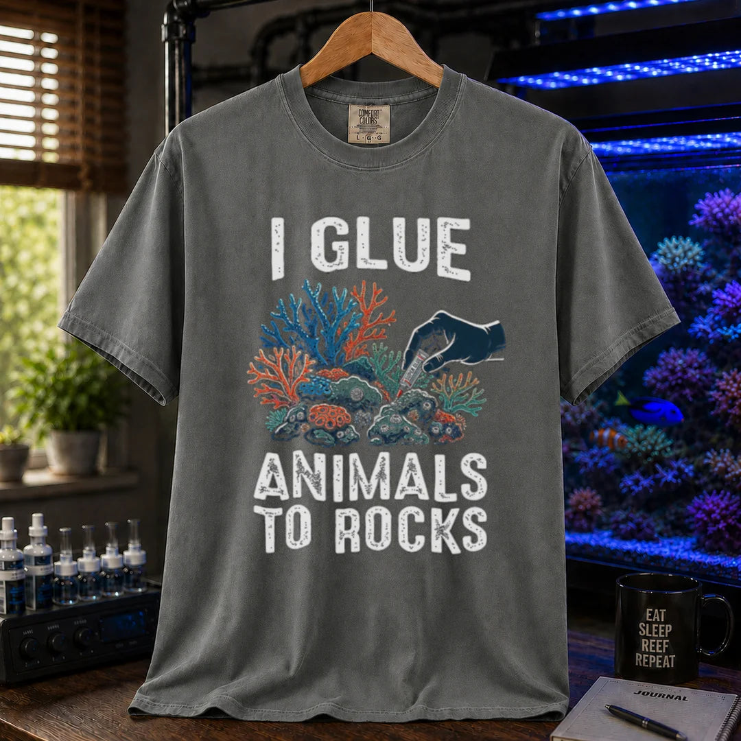 Saltwater aquarium graphic t-shirt featuring a hand gluing coral to rock illustration and text: I GLUE ANIMALS TO ROCKS, grey crew neck tee