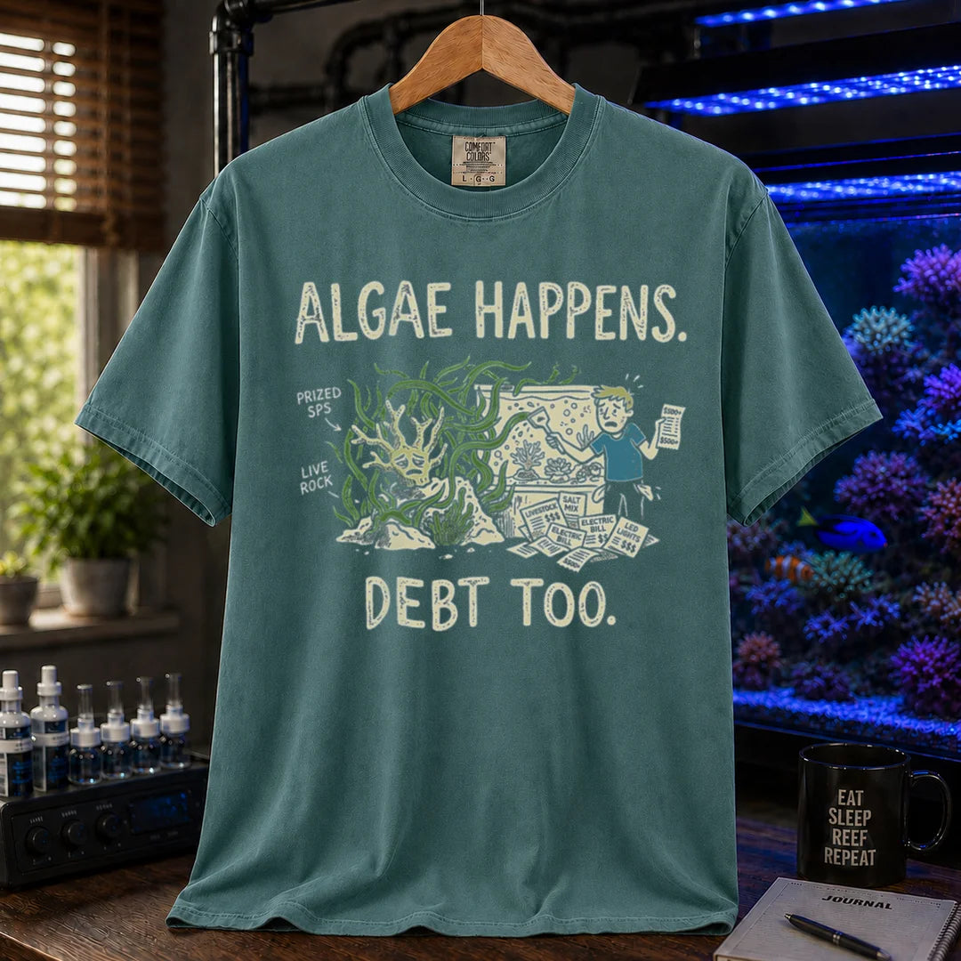 Saltwater aquarium graphic t-shirt featuring an overgrown tank and stressed aquarist illustration with text: ALGAE HAPPENS. DEBT TOO., green crew neck tee