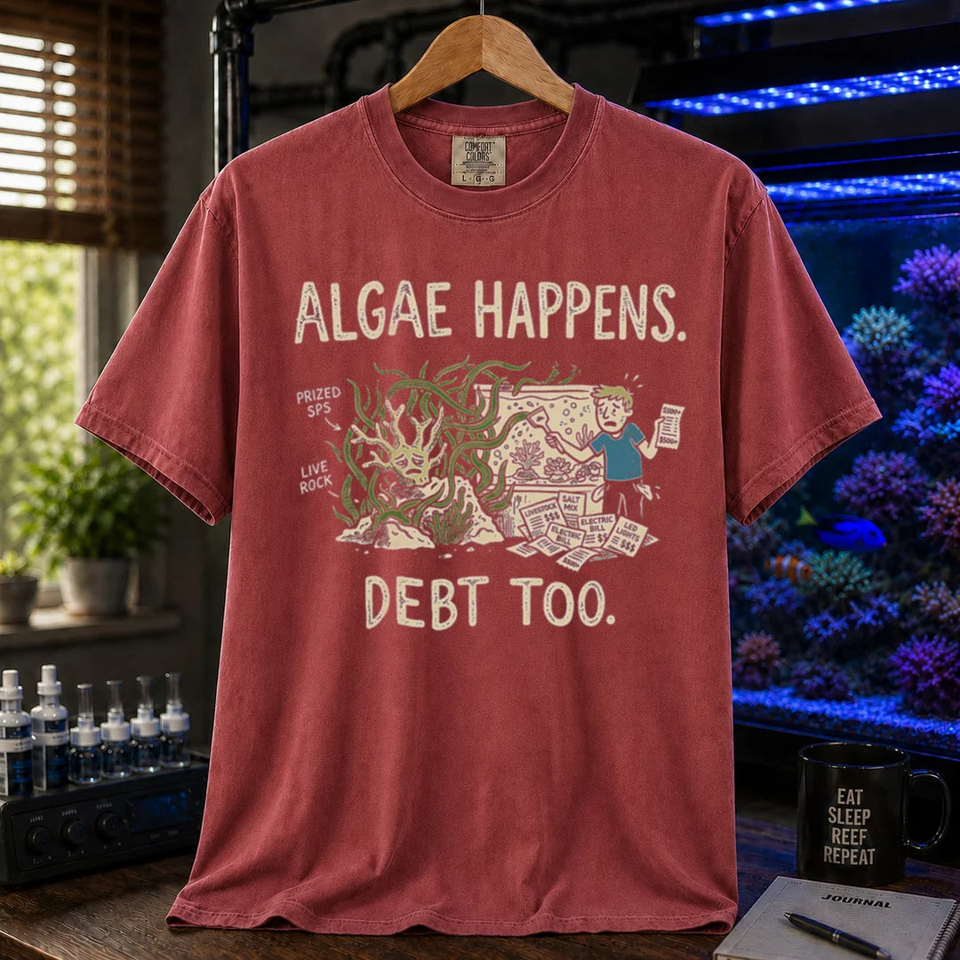 Saltwater aquarium graphic t-shirt featuring an overgrown tank and stressed aquarist illustration with text: ALGAE HAPPENS. DEBT TOO., maroon, red crew neck tee