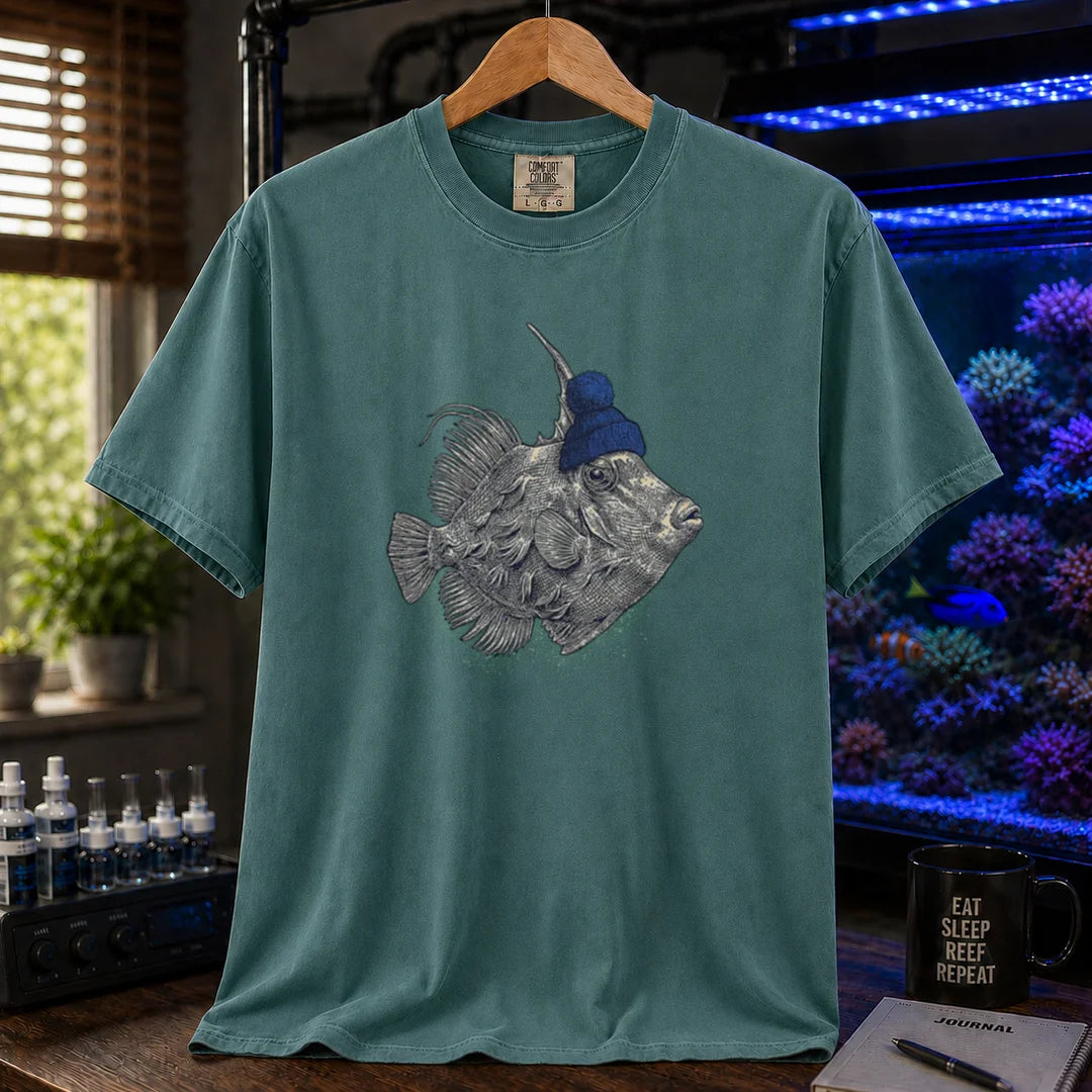 Saltwater aquarium graphic t-shirt featuring a filefish wearing a blue beanie illustration, green crew neck te