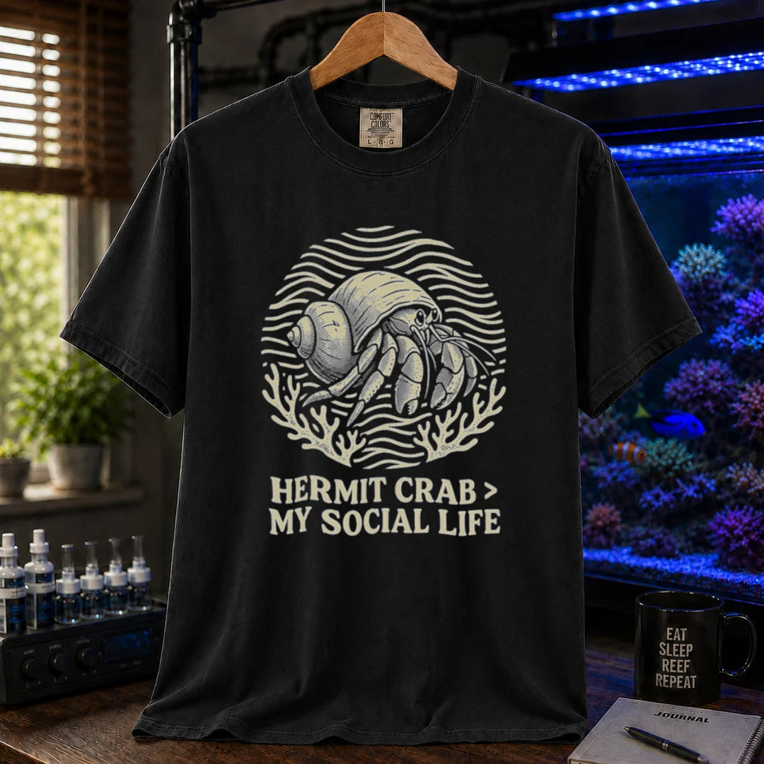 Saltwater aquarium graphic t-shirt featuring a hermit crab illustration and text: HERMIT CRAB > MY SOCIAL LIFE, black crew neck tee