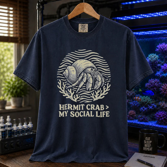 Saltwater aquarium graphic t-shirt featuring a hermit crab illustration and text: HERMIT CRAB > MY SOCIAL LIFE, navy crew neck tee