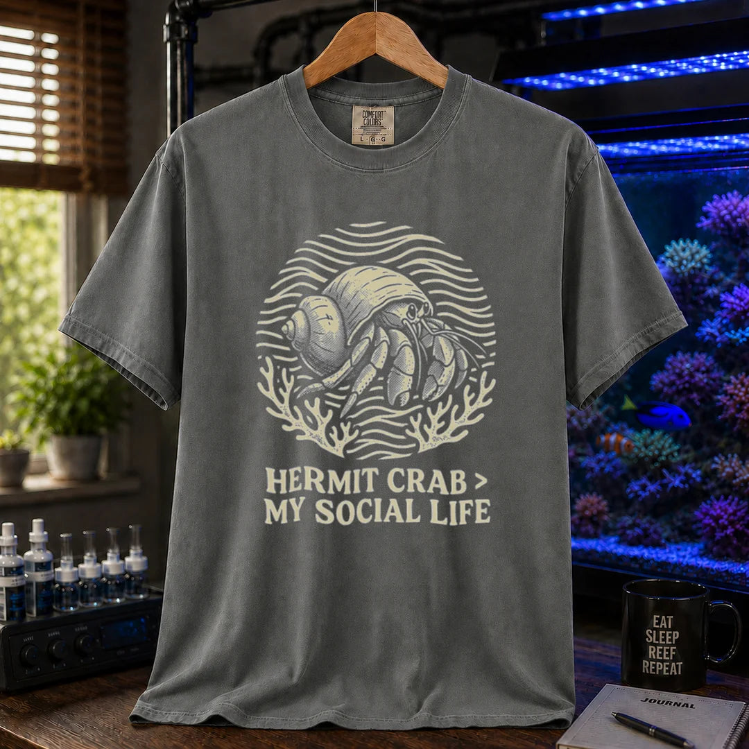 Saltwater aquarium graphic t-shirt featuring a hermit crab illustration and text: HERMIT CRAB > MY SOCIAL LIFE, dark grey crew neck tee