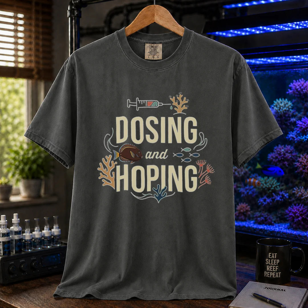 Saltwater aquarium graphic t-shirt featuring a dosing syringe and coral illustration with text: DOSING and HOPING, dark grey crew neck tee
