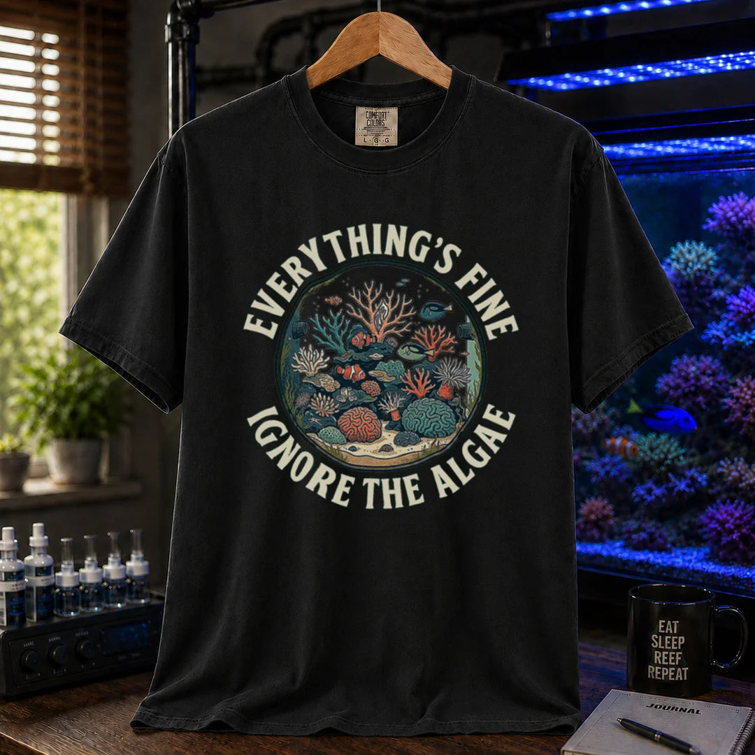 Saltwater aquarium graphic t-shirt featuring a circular reef tank illustration and curved text: EVERYTHING'S FINE IGNORE THE ALGAE, black crew neck tee