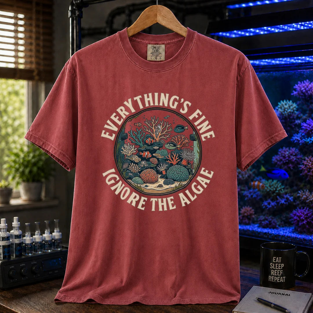 Saltwater aquarium graphic t-shirt featuring a circular reef tank illustration and curved text: EVERYTHING'S FINE IGNORE THE ALGAE, maroon, red crew neck tee