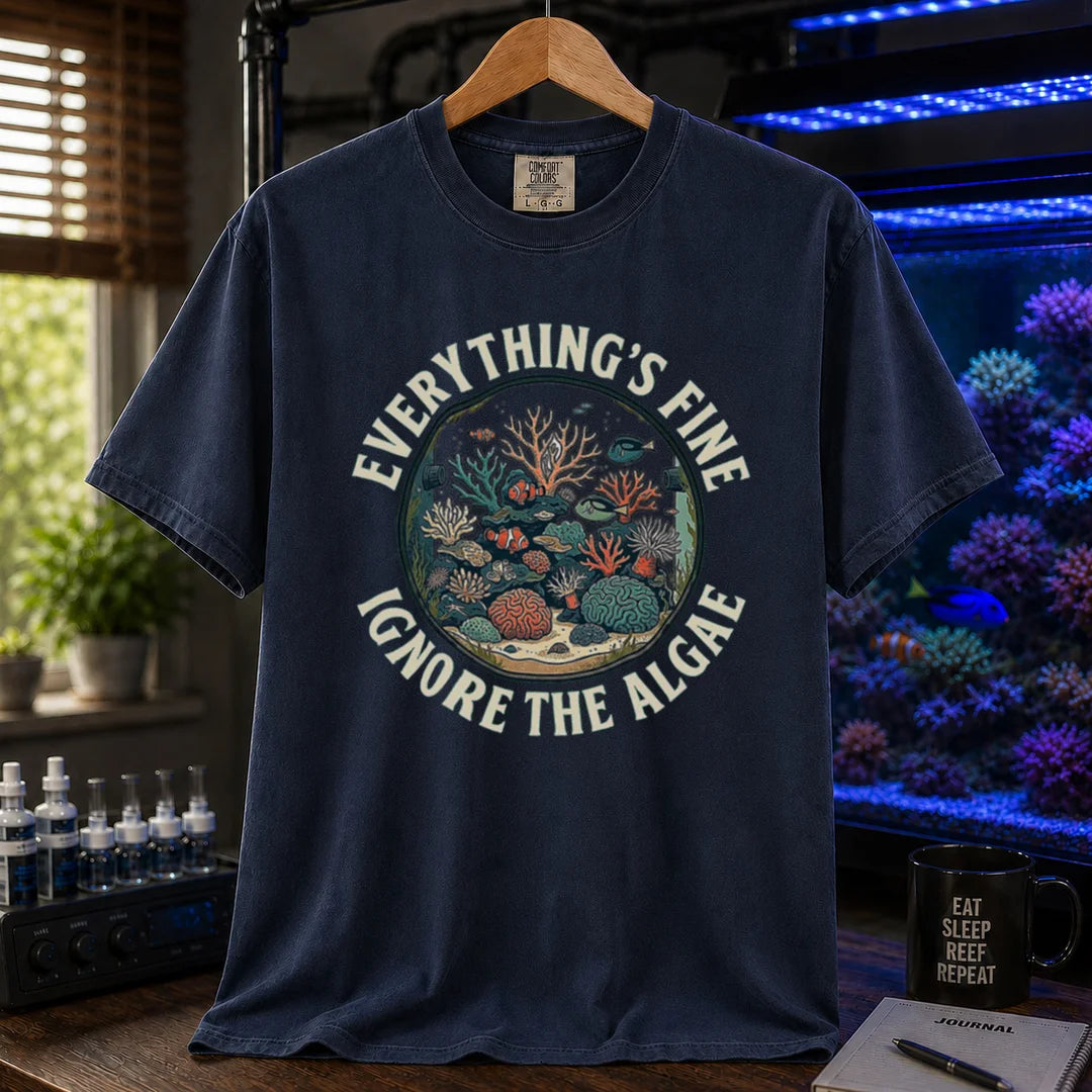 Saltwater aquarium graphic t-shirt featuring a circular reef tank illustration and curved text: EVERYTHING'S FINE IGNORE THE ALGAE, navy crew neck tee