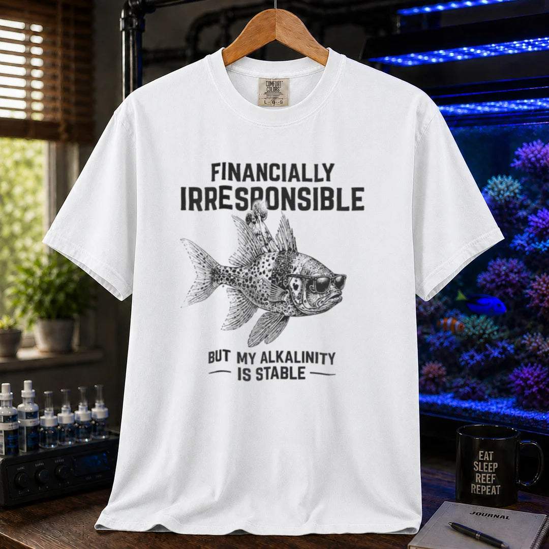 Saltwater aquarium graphic t-shirt featuring a fish in sunglasses illustration and text: FINANCIALLY IRRESPONSIBLE BUT MY ALKALINITY IS STABLE, white crew neck tee