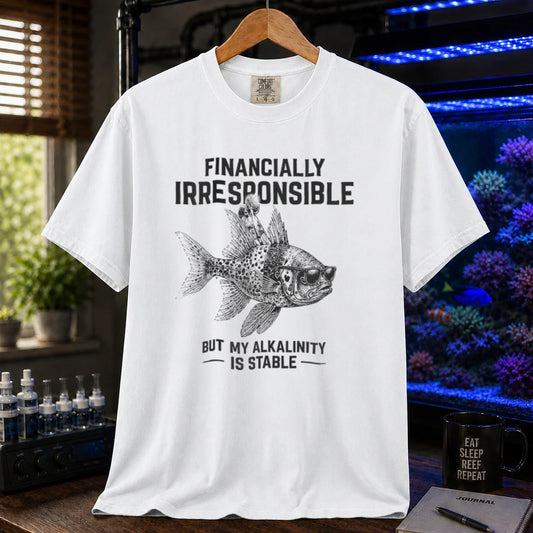 Saltwater aquarium graphic t-shirt featuring a fish in sunglasses illustration and text: FINANCIALLY IRRESPONSIBLE BUT MY ALKALINITY IS STABLE, white crew neck tee