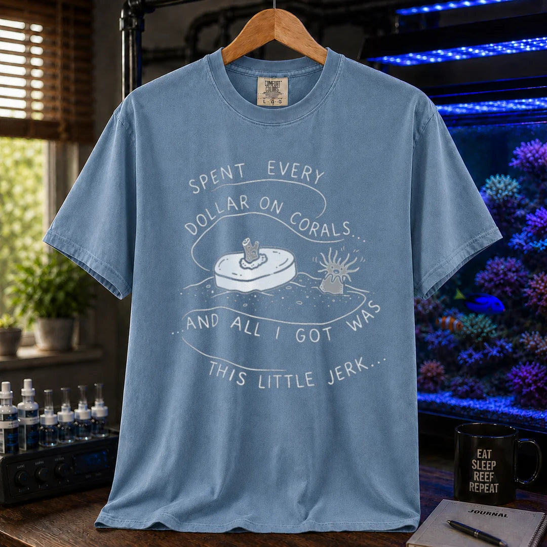 Saltwater aquarium graphic t-shirt featuring a frag plug illustration and text: SPENT EVERY DOLLAR ON CORALS... AND ALL I GOT WAS THIS LITTLE JERK..., blue crew neck tee