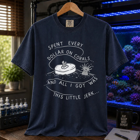 Saltwater aquarium graphic t-shirt featuring a frag plug illustration and text: SPENT EVERY DOLLAR ON CORALS... AND ALL I GOT WAS THIS LITTLE JERK..., navy crew neck tee