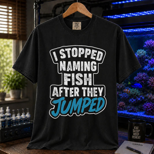 Saltwater aquarium graphic t-shirt featuring distressed block text and blue script: I STOPPED NAMING FISH AFTER THEY JUMPED, black crew neck tee